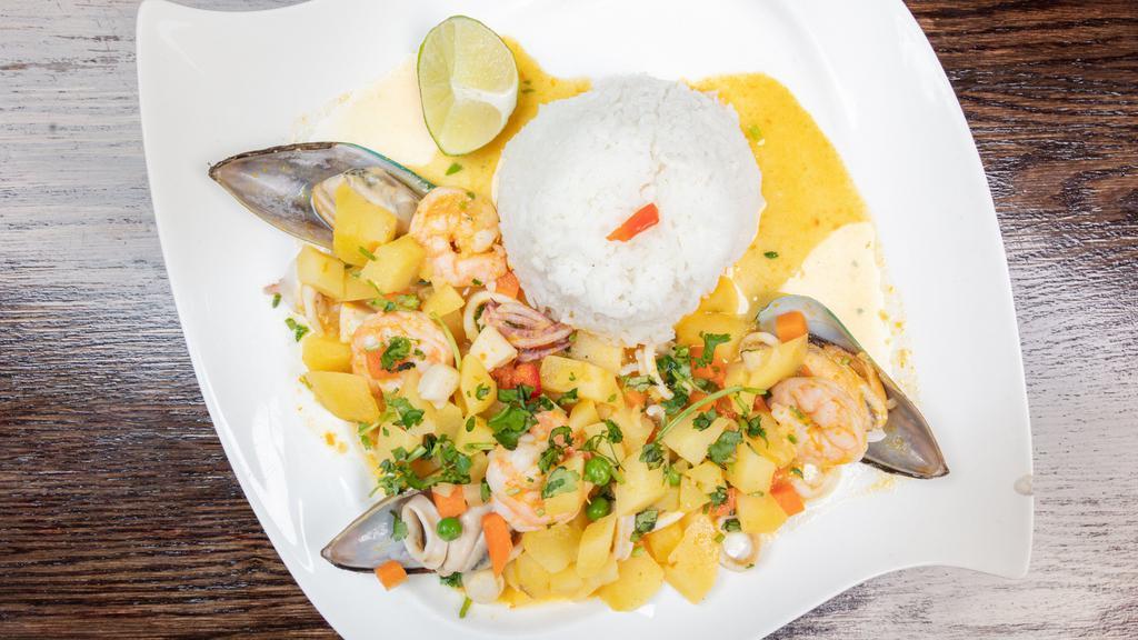 Cau Cau De Mariscos · Fresh seafood stew made of scallops, squid, mussels, and shrimp with chunk potatoes. Seasoned with Peruvian yellow pepper. Served with steamed rice and cilantro.