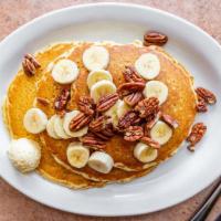 Banana Pecan Pancakes · Topped with sliced bananas and pecan pieces.