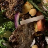 Palomilla Steak Salad · Thin sliced of marinated sirloin steak tossed with mixed greens, garbanzo beans, tomatoes, s...