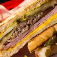 Cubano  · Slow roasted pork, hickory smoked ham, Swiss cheese, dill pickles, mayo and mustard on toast...