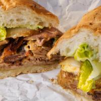 Pan Con Lechon (Pork Sandwich) · Slow roasted pork, fresh cilantro, red onion, diced stuffed green olives, Romaine lettuce, g...