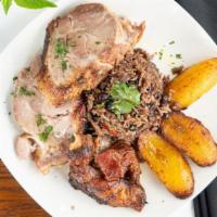 Puerco Asado (Roast Pork Entree) · Cuban style marinated slow roasted pork. Served with moros (rice, black beans, bell peppers,...