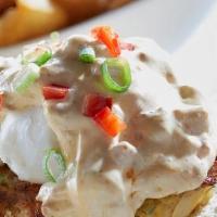 Crab Cake Benedict · Jumbo lump crab cakes on an English muffin, topped with poached eggs, andouille-infused holl...
