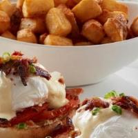 Eggs Blackstone Benedict · Grilled red tomato slices on an English muffin, topped with poached eggs, hollandaise, chopp...
