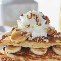 Bourbon Street Pancakes · Three house-recipe cakes topped bananas, pecans, rum butter sauce drizzle and whipped cream.