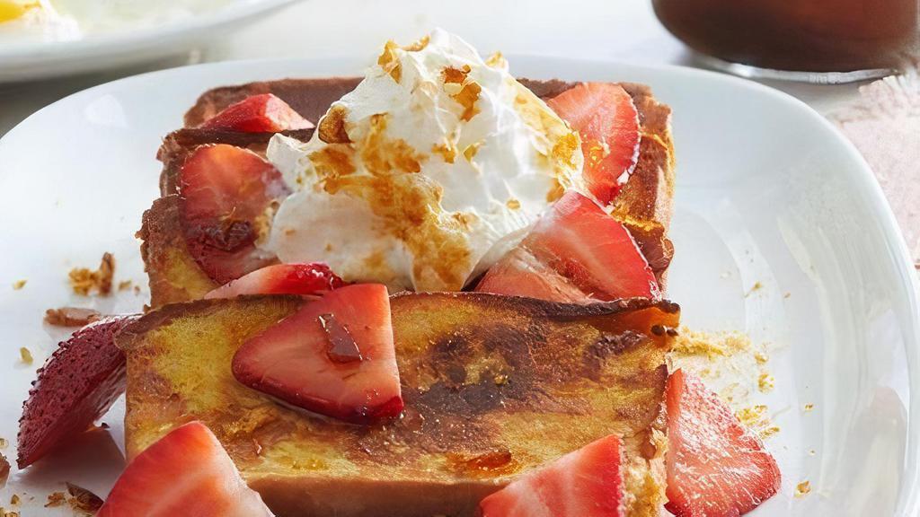 Strawberry Pound Cake French Toast Platter · 20 pieces of French-toast style pound cake topped with fresh strawberries, fresh whipped cream and crème brulee sugar. Served with butter and syrup. (Serves 10)