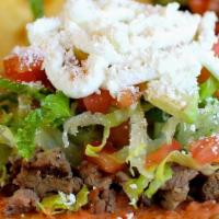Tostada · Meat, beans, lettuce, advocado, cheese, sour cream, tomatoes