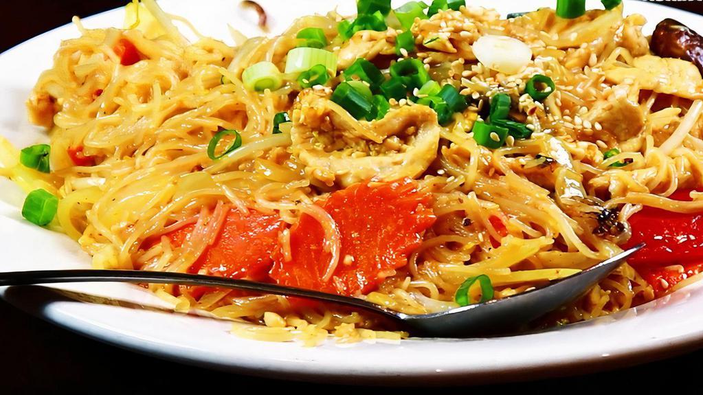 Singapore Noodles · Thin rice noodles, sautéed with vegetables and curry sauce, topped off with sesame seeds.