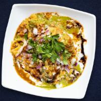 Chaat On The Heels · Vegetable Samosa topped, with Chana Masala, Onions Tomatoes, Yogurt, Cilantro, Tamarind Chut...