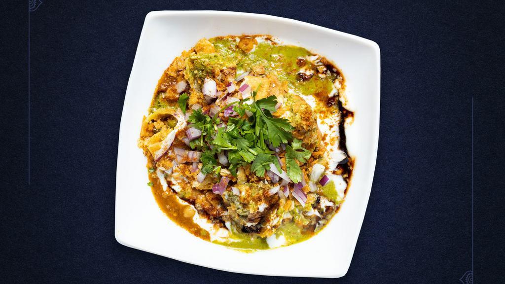 Chaat On The Heels · Vegetable Samosa topped, with Chana Masala, Onions Tomatoes, Yogurt, Cilantro, Tamarind Chutney, and Mint Chutney