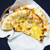 Second To Naan · Leavened flatbread made from white flour, cooked until puffy and blistering, then coated in ...
