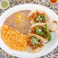 Taco · Two tacos with choice of meat and comes with a side of rice and beans.