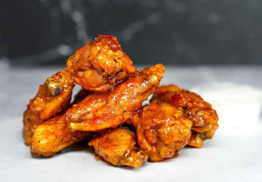 12 Classic Bone-In Wings · 12 classic bone-in chicken wings fried to perfection. Served with a side of ranch or blue cheese dressing.