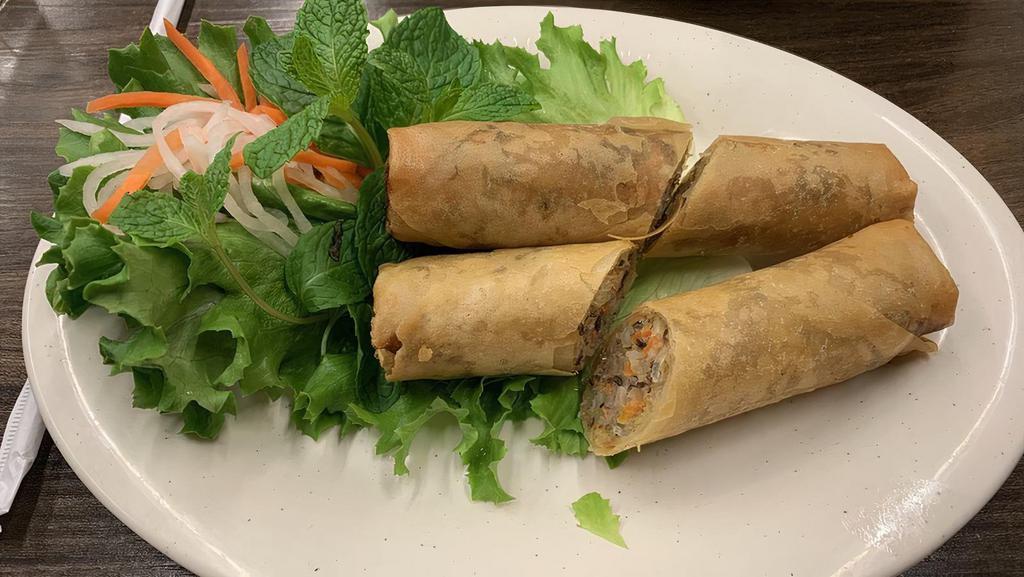 Crispy Egg Rolls · Served with a side of fish sauce.