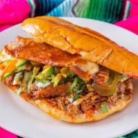 Torta De Birria  · Mexican bread with mayonnaise on the griddle, mozzarella cheese, lettuce, jalapeños, onion c...