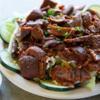 Beef & Lamb Gyro Salad · Beef and lamb gyro slices served over lettuce, tomatoes, cucumbers, olive oil, feta cheese, ...
