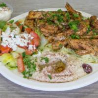 Chicken Shawarma Plate · Marinated, tender fire-grilled chicken shawarma slices served with rice, hummus, pita bread,...
