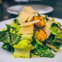 Caesar Salad · Chopped romaine lettuce, parmigiano cheese & caesar dressing.