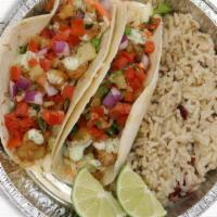 Cabo Fish Tacos · Two flour tortillas stuffed with blackened seasonal fish, pineapple salsa, cabbage, topped w...