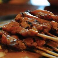 Moo Yang On Skewer · Marinated pork loin in sweet garlic sauce and grilled on a bamboo skewer.