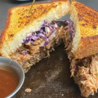 Prairie Bbq Pulled Pork Sandwich · Juicy saloon-smoked pork, WoS BBQ sauce, bread and butter pickles, coleslaw, on garlic butte...