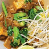 Pad See Ew · Wide rice noodles stir-fried with egg and Chinese broccoli. Served with bean sprouts and a w...