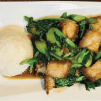Pad Kana Mhoo Krob · served with steamed rice Thai-style stir fry with crispy pork belly,. Chinese broccoli, and ...