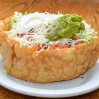 Tostada Salad · Large flour tortilla fried shell, filled with iceberg lettuce, black beans, Mexican rice, ch...