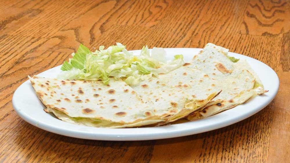 Quesadilla · Large flour tortilla filled with melted Jack cheese and guacamole.