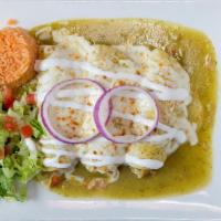 Enchiladas Suizas · 3 corn tortillas filled with chicken, beef or cheese, and covered with enchilada sauce, melt...
