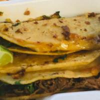 Birria Taco · Double 6 inch corn tortillas with cheese melted onto tortilla with shredded beef and cilantr...