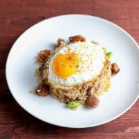 The Breakfast · Bacon, chinese sausage, egg and edamame wok-seared with rice topped with a sunny side up egg...