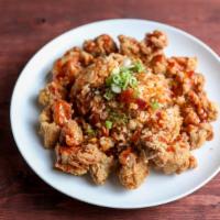 Korean Fried Chicken Fried Rice · Rice, egg, and vegetables wok-seared in a soy-based sauce.