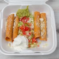 Taquitos Dorados Potatoes · Corn tortilla filled with potatoes, then rolled and fried, garnished  with lettuce, tomatoes...