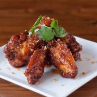 Spicy Chicken Wings · Spicy. Crispy fried chicken wings in a mai ploy fish sauce glaze.