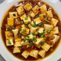 Ma Po Tofu 麻婆豆腐 · Tofu with ground pork set in a spicy sauce .