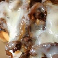 (T) Philly Cheesesteak · Shaved rib-eye steak, caramelized onions, and provolone on a toasted hoagie roll.