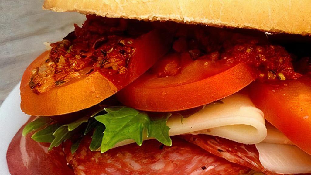 (T) Classic Cold-Cut Italian Sub · Genoa salami, capocolla, ham, provolone, lettuce, tomato and onion on a hoagie roll.