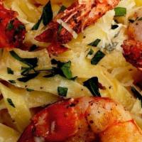 (T) Shrimp Scampi · Four large shrimp, served with fettuccine and topped with a classic butter, lemon and wine s...