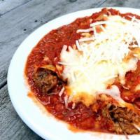 (T) Baked Short Rib Cannelloni · Pasta sheets rolled and filled with braised boneless short ribs and Italian cheeses, topped ...