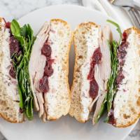 Turkey Cranberry · Deli Turkey, herbed cream cheese, cranberry sauce and mixed greens on whole grain or ciabatta.