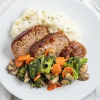 Classic Meatloaf · With mashed potatoes and seasoned vegetables.