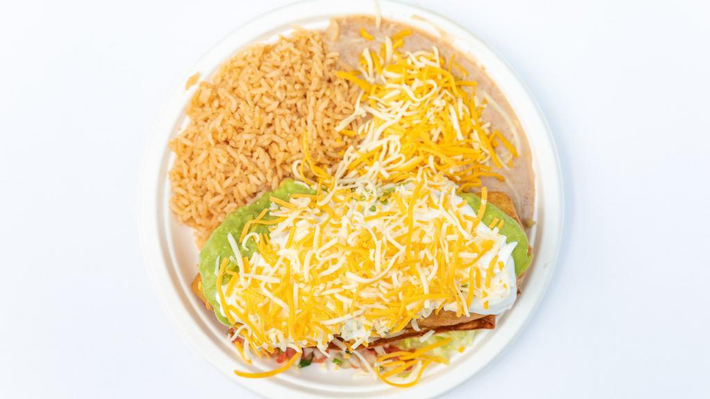 #20  Chimichanga Plate · Deep fried burrito filled with beans and cheese and your choice of shredded beef that is mixed with bell pepper onion and tomato, or shredded chicken. Topped with guacamole, sour cream, and cheese. Garnished with lettuce and pico de gallo.
