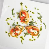 Bruschetta · Grilled bread, goat cheese, roasted red peppers and basil.