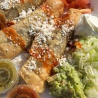 Taquitos Dorados · Choice of meat, sour cream, guacamole, tomatoes, cheese, lettuce, salsa, served with rice an...