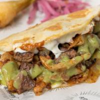 El Chingon Taco · Three meats - chicken, pork and beef with fajita-style veggies on a flour tortilla.
