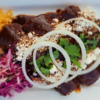Mole Enchiladas · Three (white meat) chicken enchiladas made with traditional Oaxacan mole sauce, rice, and sa...