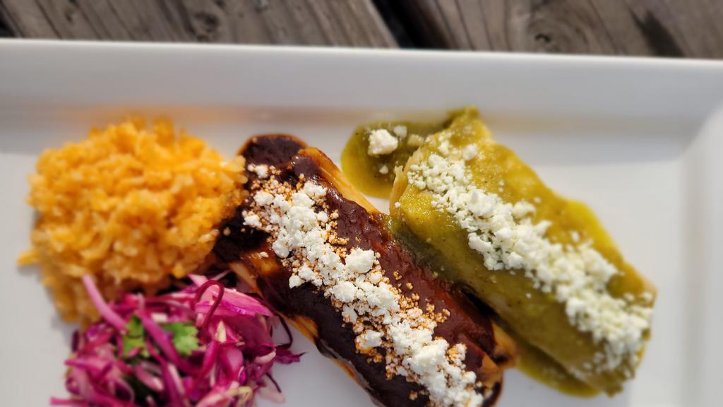 Tamale Plate · Two steaming tamales served with rice and salad. Topped with queso fresco, jalapeños. and sauce. Choice of braised pork (mole), shredded chicken (chili verde), or rajas (Oaxacan cheese).