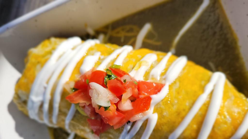 Burritos Locos · rice,beans, cilantro, onions.Topped with more chile sauce and choice of meat, pico, sour cream, chips, and lots of melted Jack cheese.