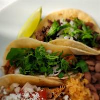 Taco Plate · Comes with rice, beans and three tacos Asada, Chicken and Al Pastor